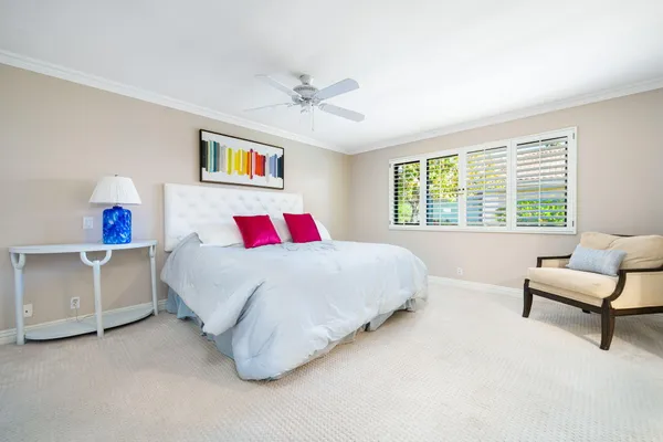 a spacious bedroom with a bed and a couch
