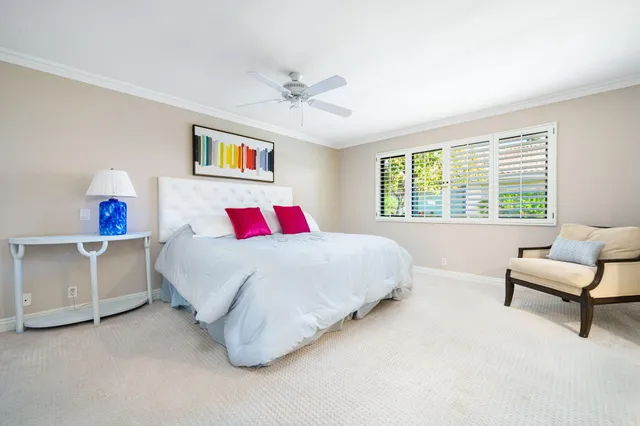 a spacious bedroom with a bed and a couch