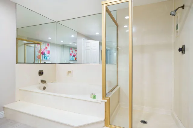 a bathroom with a bathtub a shower and a sink