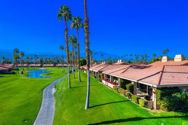 a view of an house with swimming pool and yard