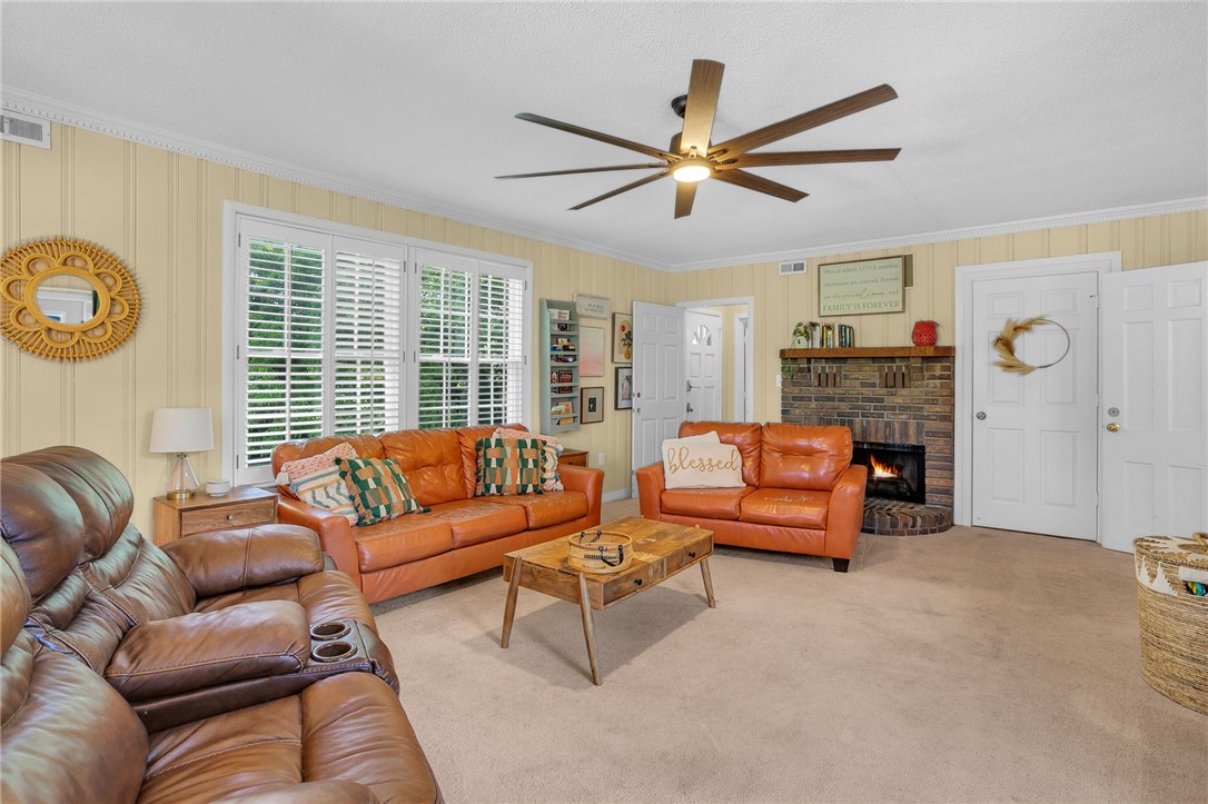 1107 Springdale Road Anderson, SC 29621 - Photo 10 of 49 This inviting living area features a warm fireplace, creating a cozy and comfortable atmosphere.