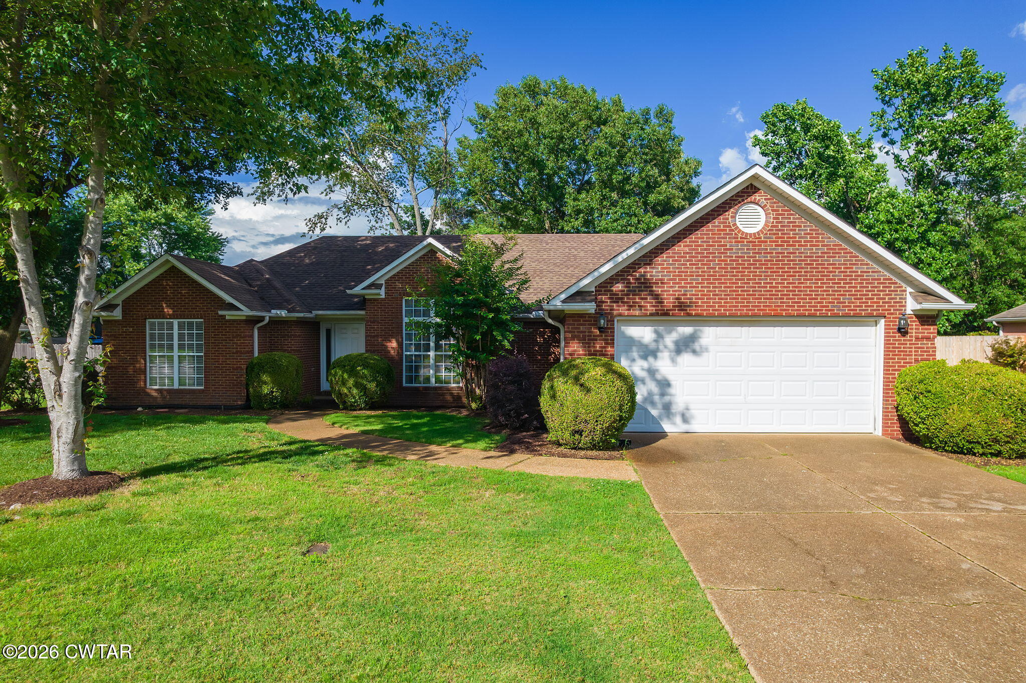 96 Sundown Drive Jackson, TN 38305 - Photo 2 of 28 a front view of a house with a yard and garage