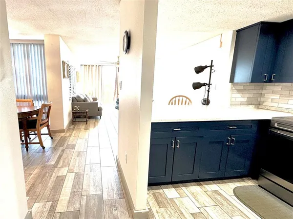a kitchen with granite countertop a sink and a stove