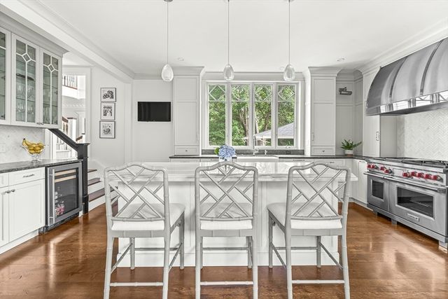 a kitchen with stainless steel appliances a stove a sink and a refrigerator