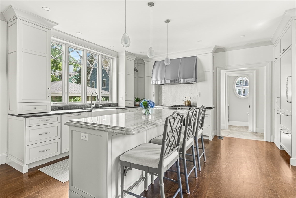 5 Stratford Road Winchester, MA 01890 - Photo 14 of 39 a view of a dining room and livingroom with furniture wooden floor a chandelier