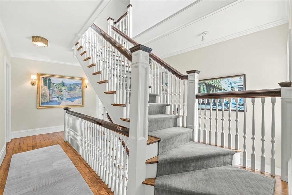 5 Stratford Road Winchester, MA 01890 - Photo 21 of 39 a view of staircase with lots of frames on wall and a window