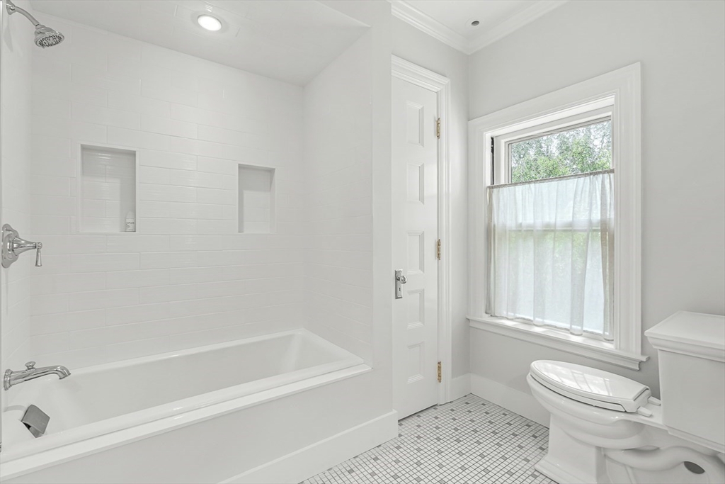 5 Stratford Road Winchester, MA 01890 - Photo 27 of 39 a bathroom with a toilet a sink and a bathtub