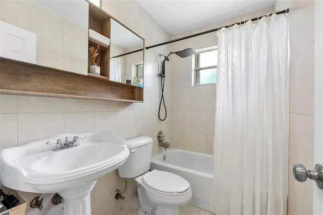 a white toilet sitting next to a bathroom sink