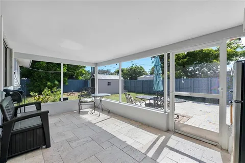 a building outdoor space with patio furniture and potted plants