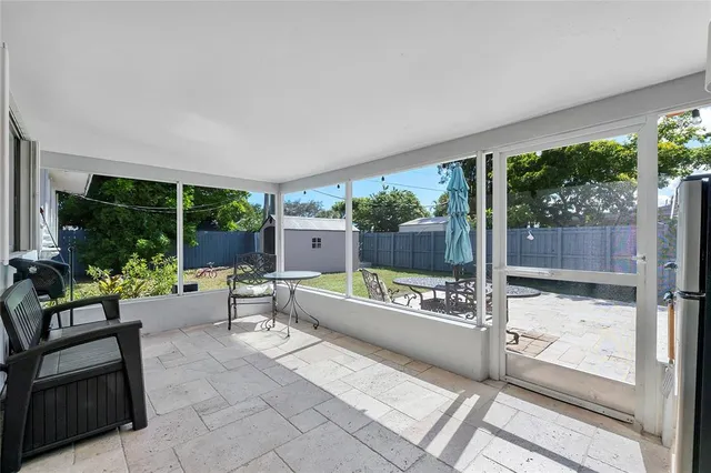 a building outdoor space with patio furniture and potted plants