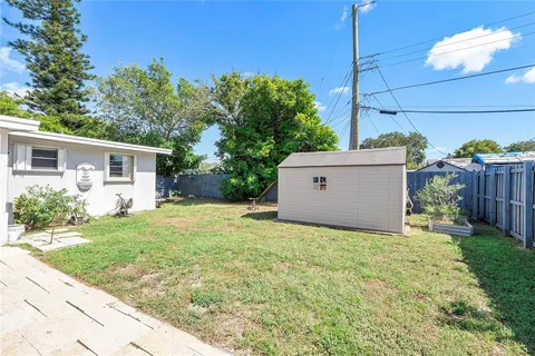 a view of a house with backyard and a garden