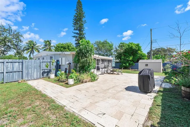 a park view with potted plants and wooden fence