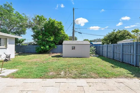 a view of a backyard with plants and trees