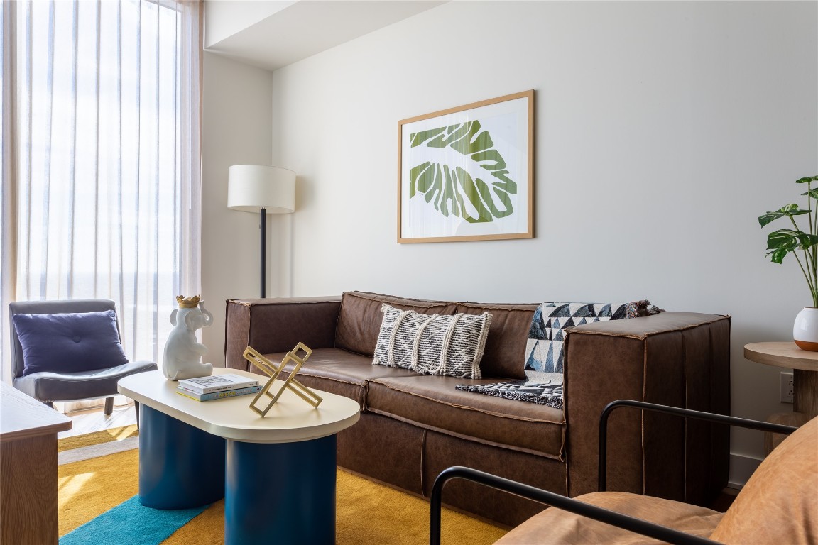a living room with furniture and a lamp
