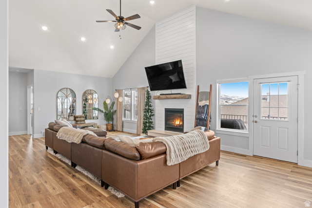 1343 North Trapper Loop Garden City, UT 84028 - Photo 9 of 56 Living room with a high ceiling, a fireplace, light wood-style floors, ceiling fan, and recessed lighting