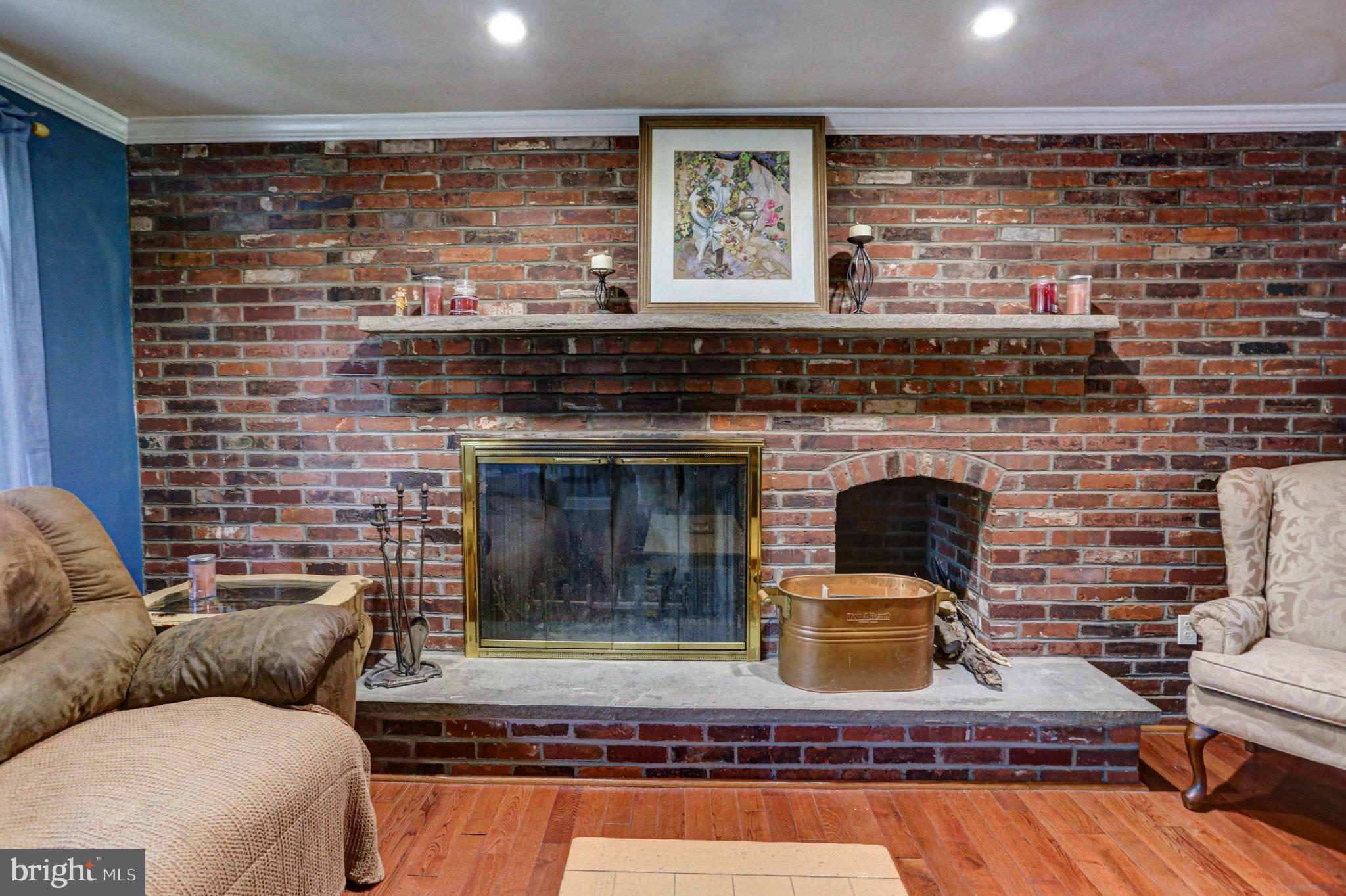 125 West Thomson Avenue Springfield, PA 19064 - Photo 12 of 41 Cozy brick fireplace with rustic charm.