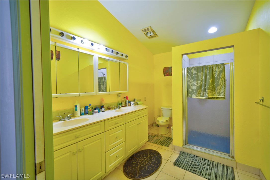 4050 Staley Road Fort Myers, FL 33905 - Photo 13 of 25 a bathroom with a sink mirror vanity and toilet