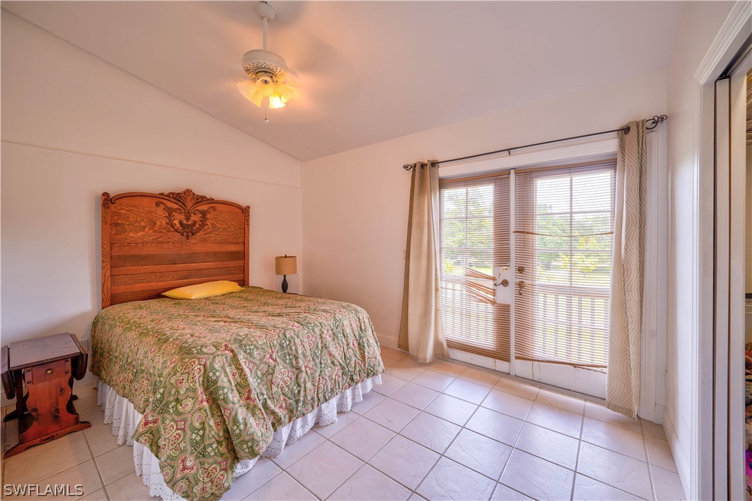 4050 Staley Road Fort Myers, FL 33905 - Photo 16 of 25 a bedroom with a bed and a chandelier