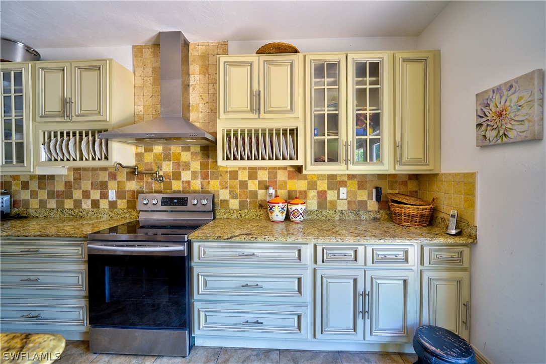4050 Staley Road Fort Myers, FL 33905 - Photo 5 of 25 a kitchen with stainless steel appliances granite countertop a stove and a sink
