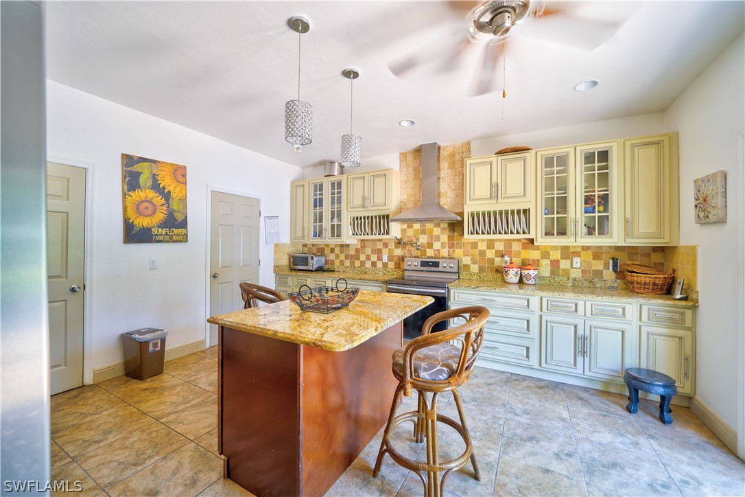 4050 Staley Road Fort Myers, FL 33905 - Photo 6 of 25 a kitchen with stainless steel appliances granite countertop a sink a stove and a refrigerator