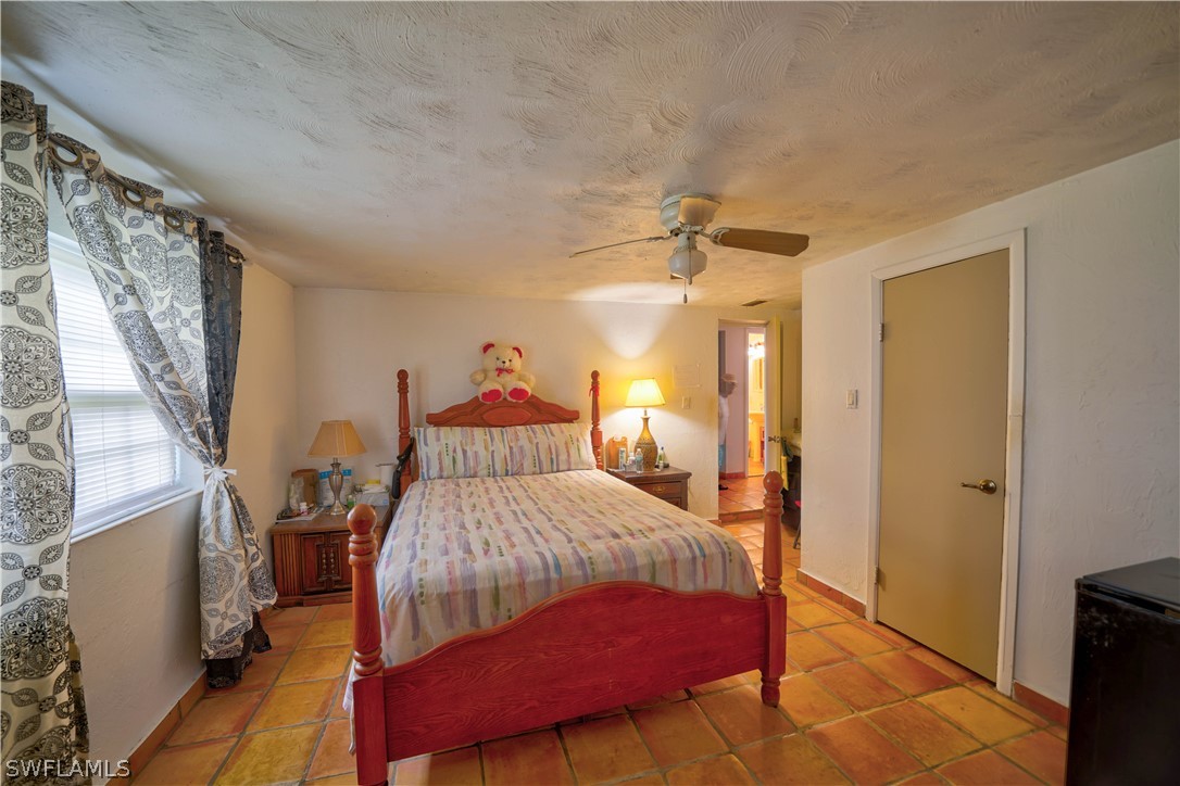 4050 Staley Road Fort Myers, FL 33905 - Photo 10 of 25 a bedroom with a bed and a mirror on dresser