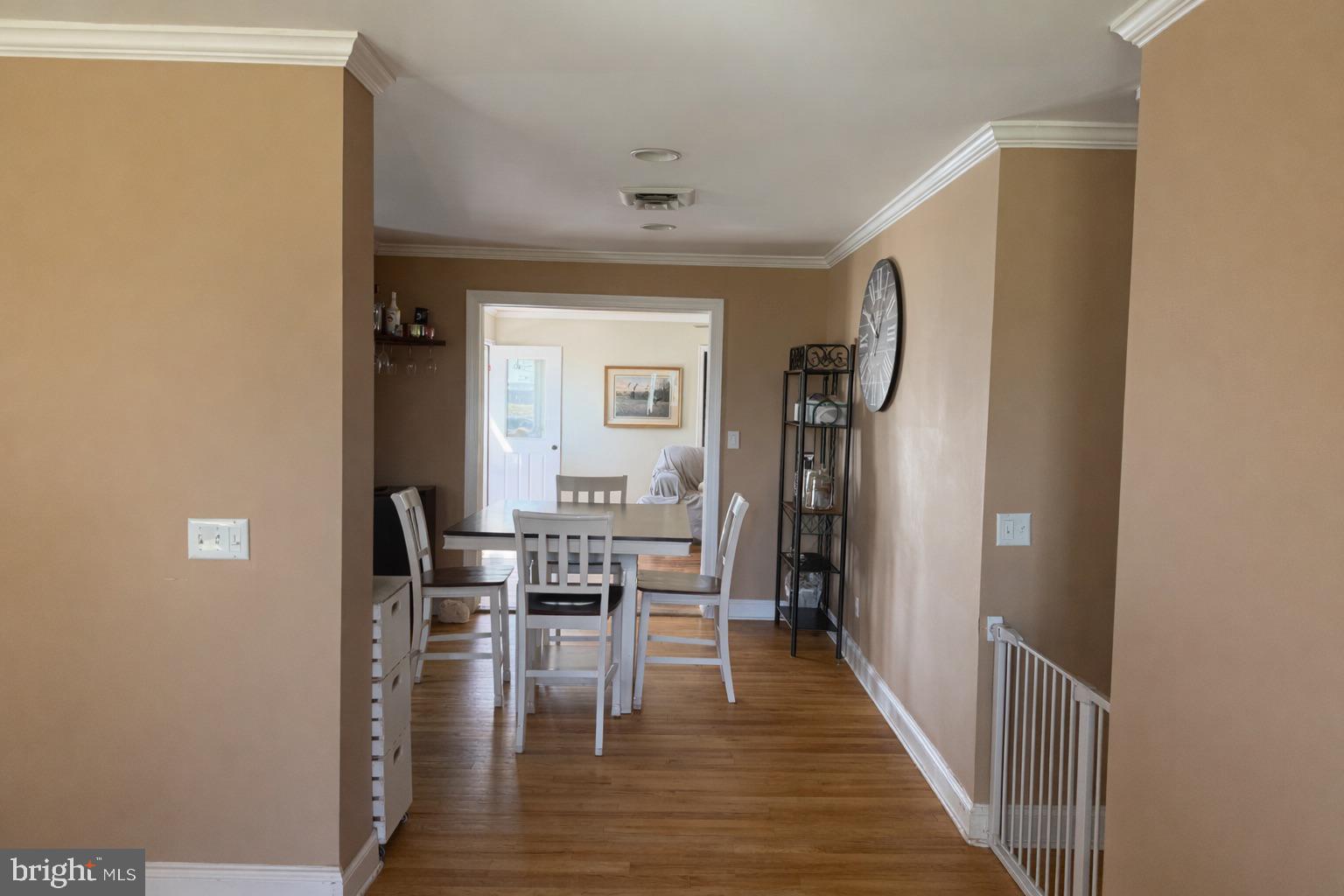5020 Bucktown Road Cambridge, MD 21613 - Photo 3 of 20 a view of hallway with dining room and wooden floor