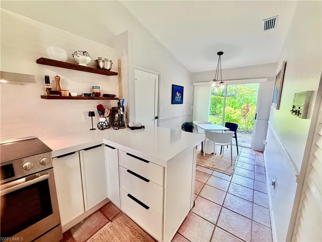 a kitchen with stainless steel appliances a stove a sink and a refrigerator