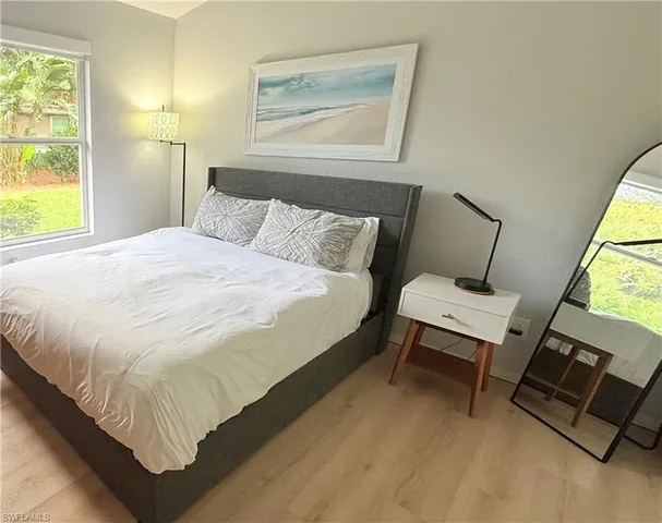 a bed sitting in a bedroom next to a window