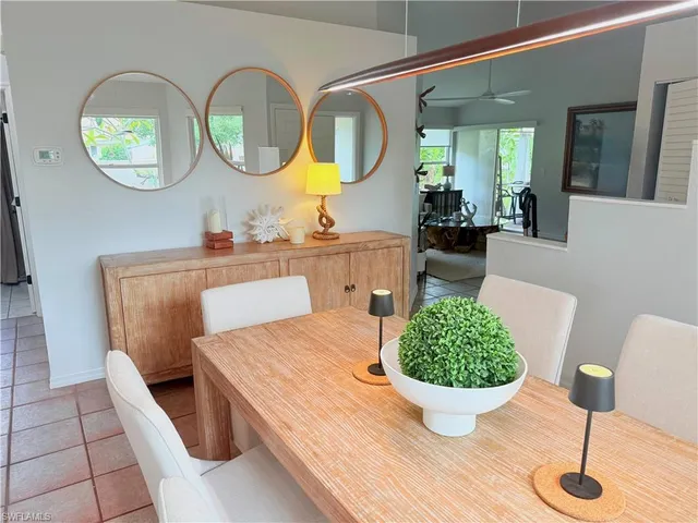 a living room with furniture a mirror and a table