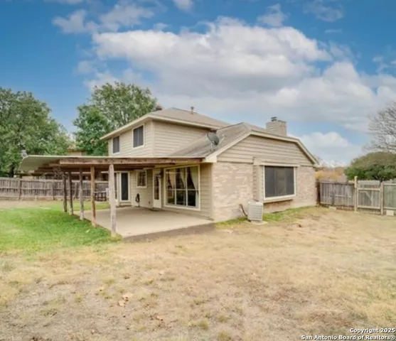 a view of a house with a yard and sitting area