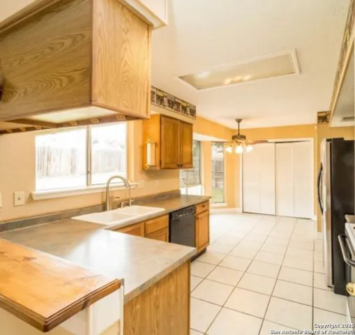a large white kitchen with a large window