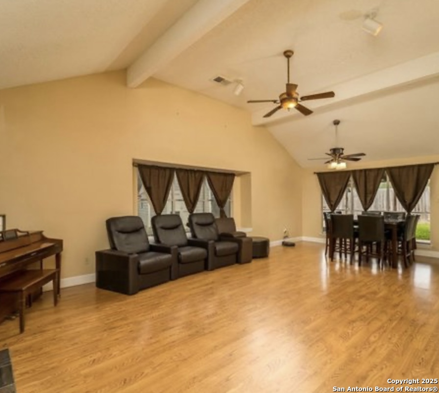 15022 Baycliff San Antonio, TX 78233 - Photo 6 of 15 a living room with furniture and a dining table with projector