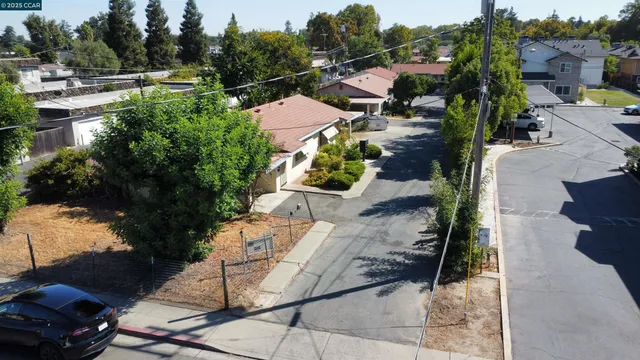 an aerial view of multiple houses with yard