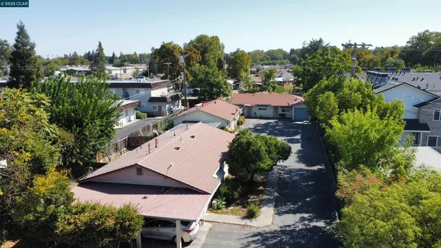 an aerial view of multiple houses with yard