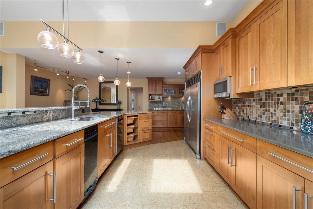 24 Russett Hill Road Sherborn, MA 01770 - Photo 8 of 39 a large kitchen with stainless steel appliances lots of counter space and a sink