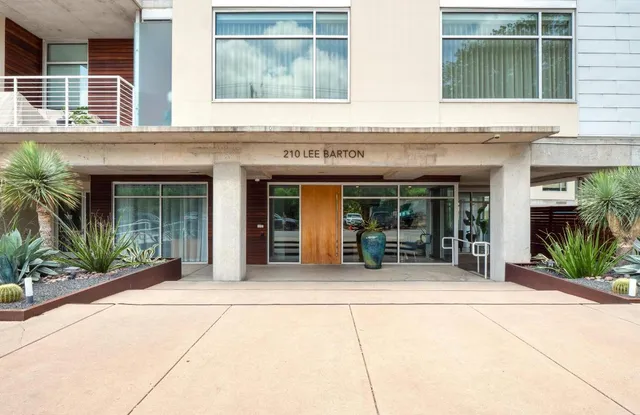 front view of a brick house with a large window