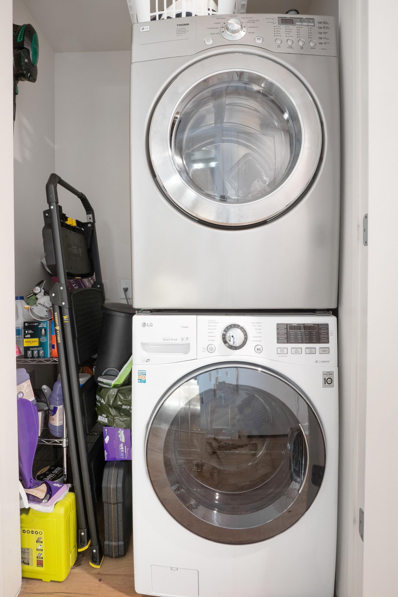 210 Lee Barton Drive, Unit 415 Austin, TX 78704 - Photo 11 of 22 Laundry area featuring stacked washer / drying machine, wood finished floors, and laundry area