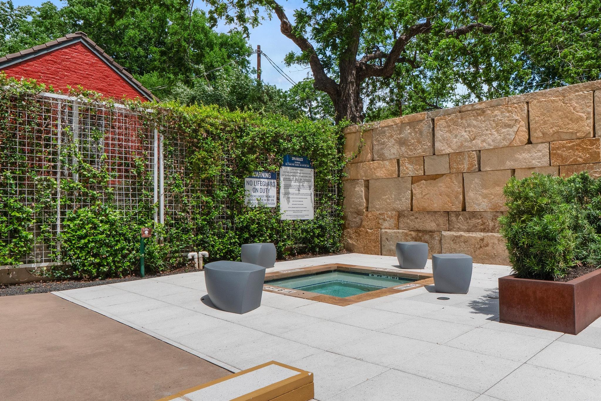 210 Lee Barton Drive, Unit 415 Austin, TX 78704 - Photo 15 of 22 View of swimming pool featuring a patio area, a hot tub, and fence
