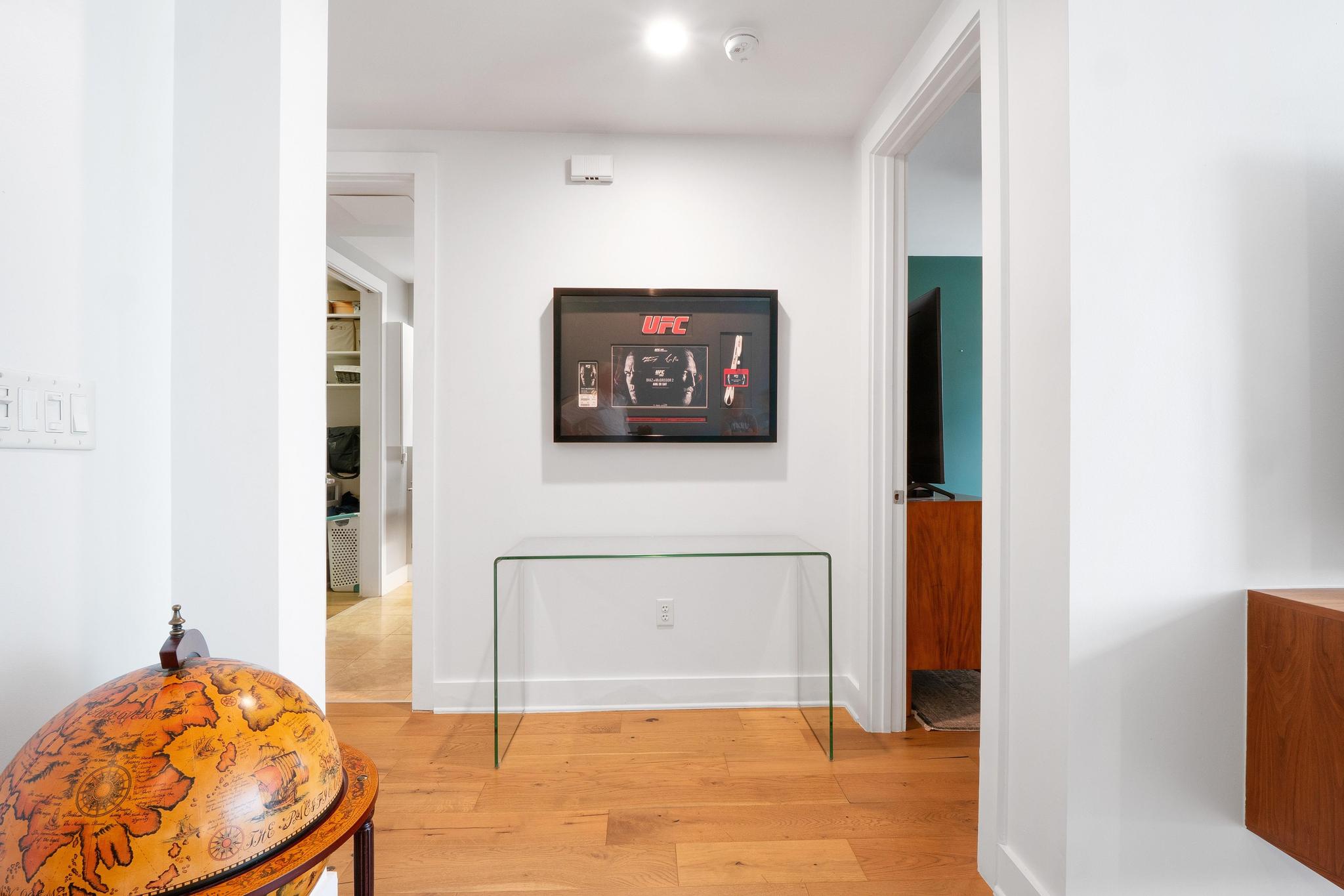 210 Lee Barton Drive, Unit 415 Austin, TX 78704 - Photo 5 of 22 Corridor with baseboards and light wood-type flooring