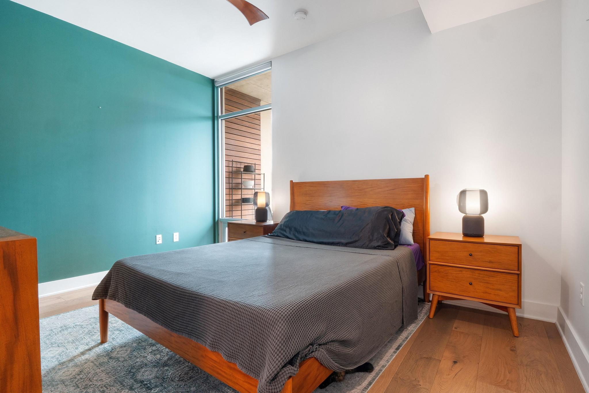 210 Lee Barton Drive, Unit 415 Austin, TX 78704 - Photo 6 of 22 Bedroom with baseboards, ceiling fan, and wood finished floors