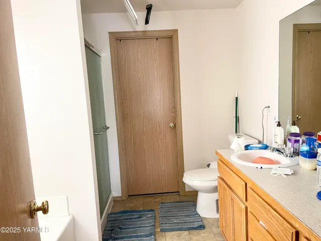 a bathroom with a sink a toilet and shower curtain