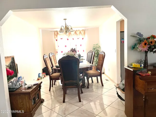 a view of a dining room with furniture and a potted plant