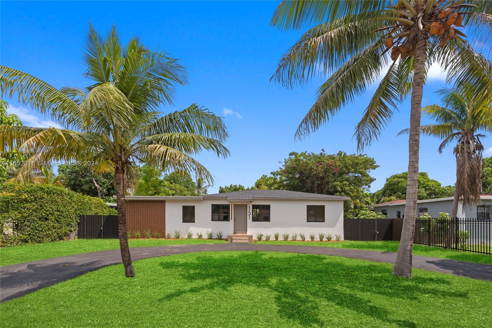 151 Northwest 146th Street Miami, FL 33168 - Photo 1 of 35 a front view of house with yard and porch