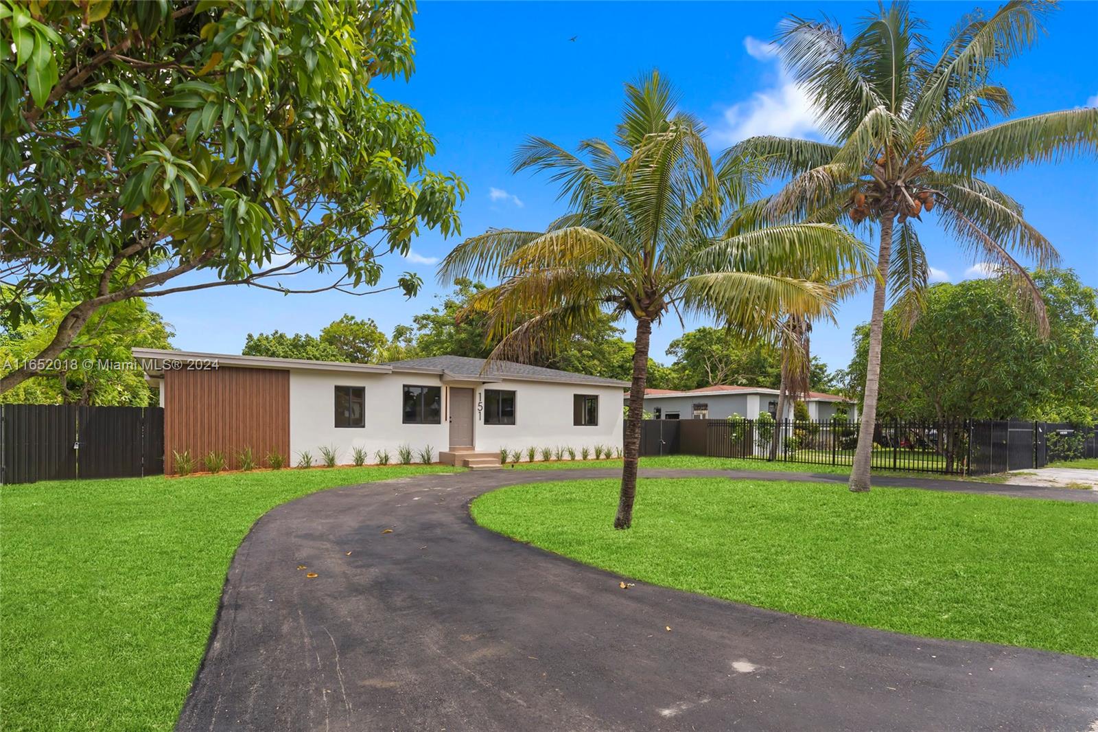 151 Northwest 146th Street Miami, FL 33168 - Photo 2 of 35 a front view of house with yard and green space
