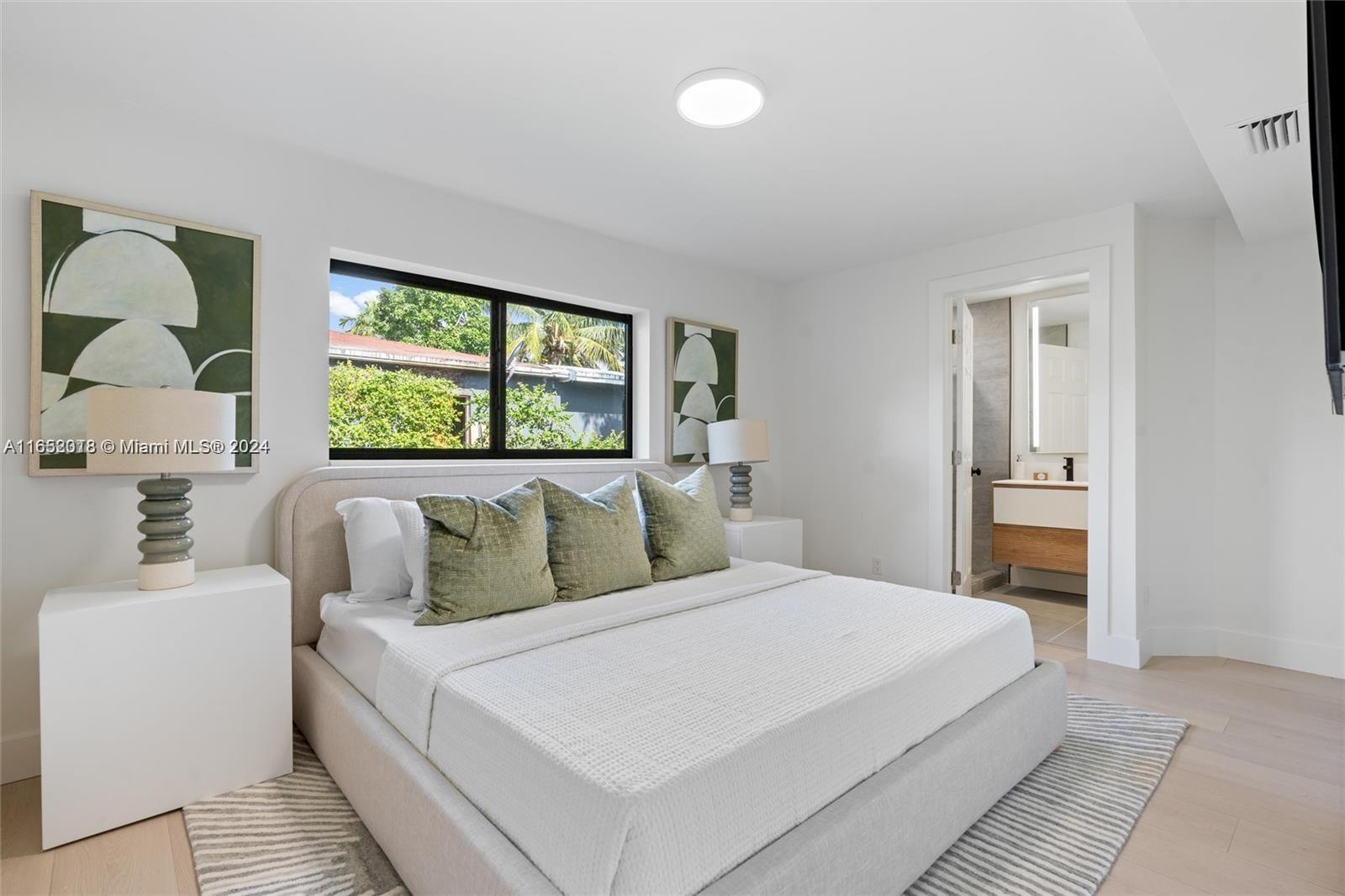 151 Northwest 146th Street Miami, FL 33168 - Photo 21 of 35 a bedroom with a large bed and a window