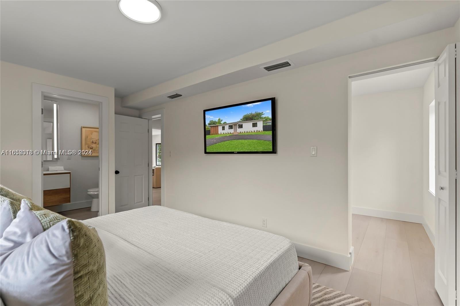 151 Northwest 146th Street Miami, FL 33168 - Photo 22 of 35 a bedroom with a bed and a painting on the wall