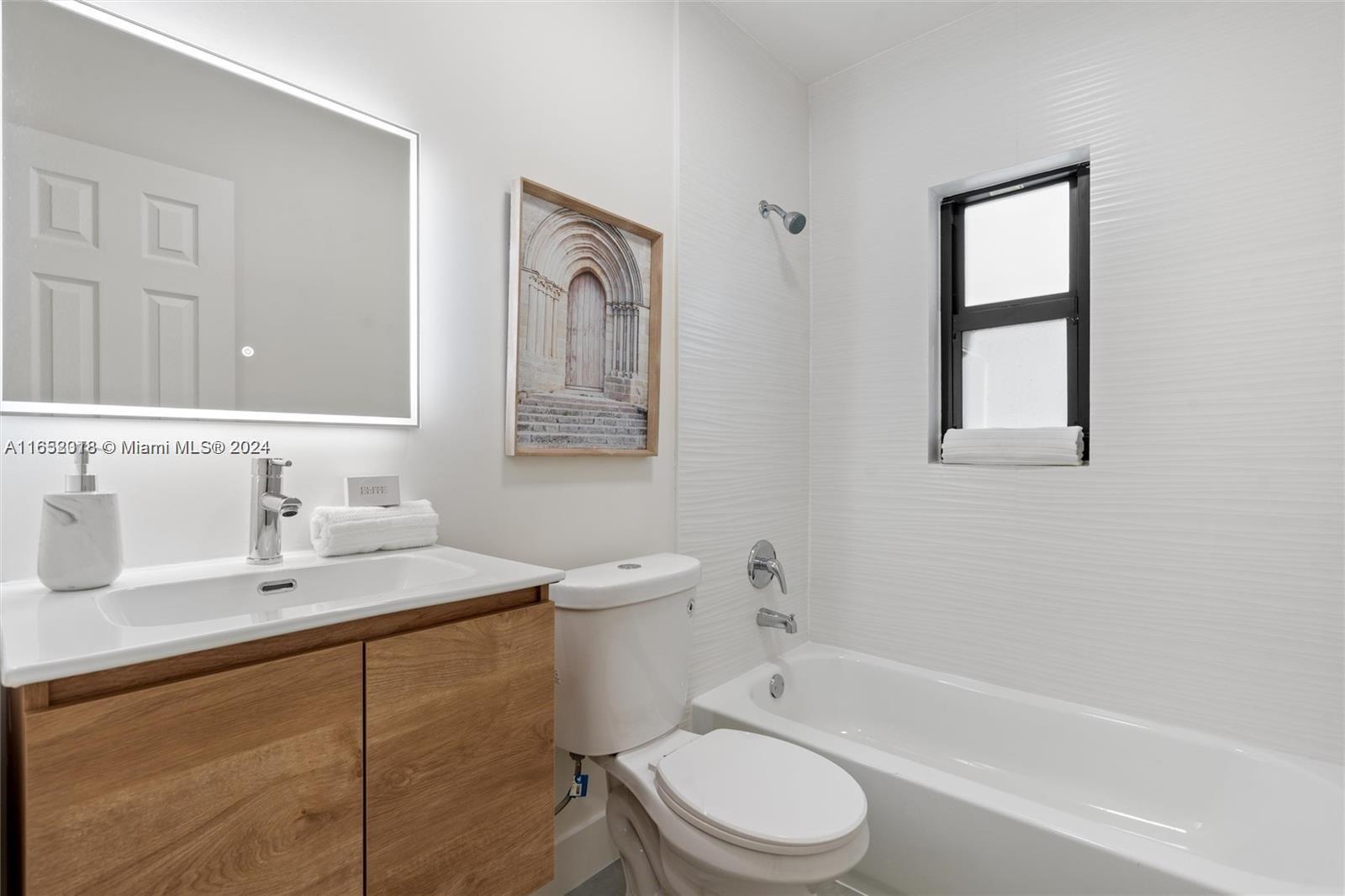 151 Northwest 146th Street Miami, FL 33168 - Photo 24 of 35 a bathroom with a sink toilet a mirror and bathtub