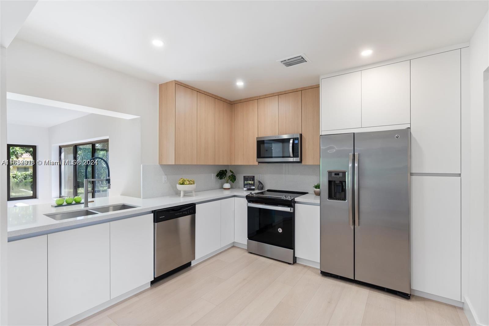151 Northwest 146th Street Miami, FL 33168 - Photo 10 of 35 a kitchen with stainless steel appliances granite countertop a refrigerator and a sink