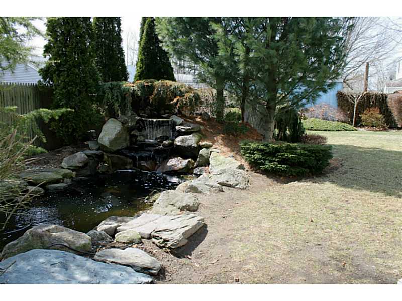 74 Greylock Road Bristol, RI 02809 - Photo 15 of 16 Exterior Front. Koi Pond and Fountain w/ lights