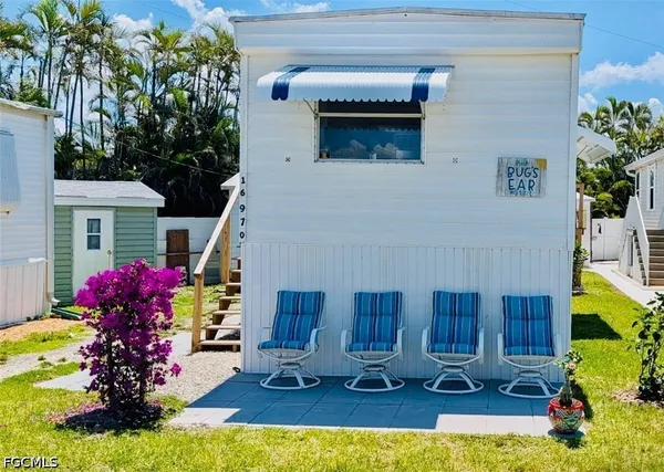a view of a house with backyard tub and outdoor seating